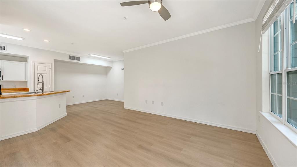 5561 Rosehill Road, Unit 104 Sarasota, FL 34233 - Photo 6 of 53 wooden floor in an empty room with a window