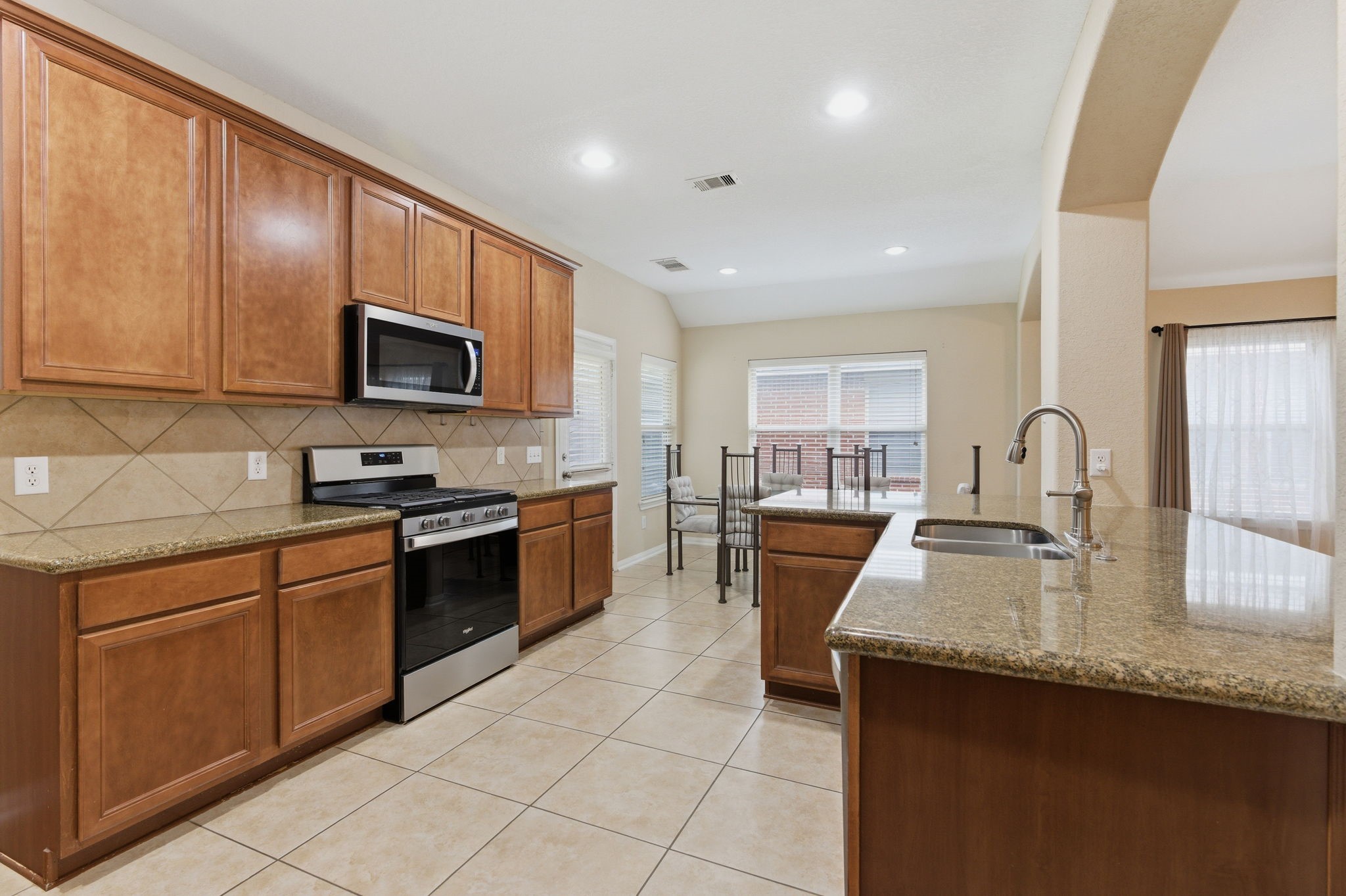 21822 Mount Hunt Drive Spring, TX 77388 - Photo 12 of 26 Elegant 42" cabinets offer ample storage and a sleek look, enhancing the kitchen's functionality and style.