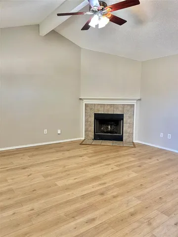 an empty room with a fireplace and fan
