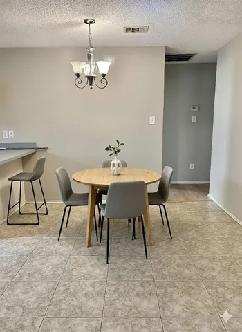 a dining room with furniture and chandelier