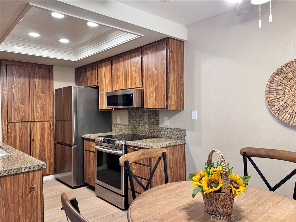25611 Quail Run, Unit 61 Dana Point, CA 92629 - Photo 19 of 29 a kitchen with stainless steel appliances granite countertop a refrigerator sink and stove