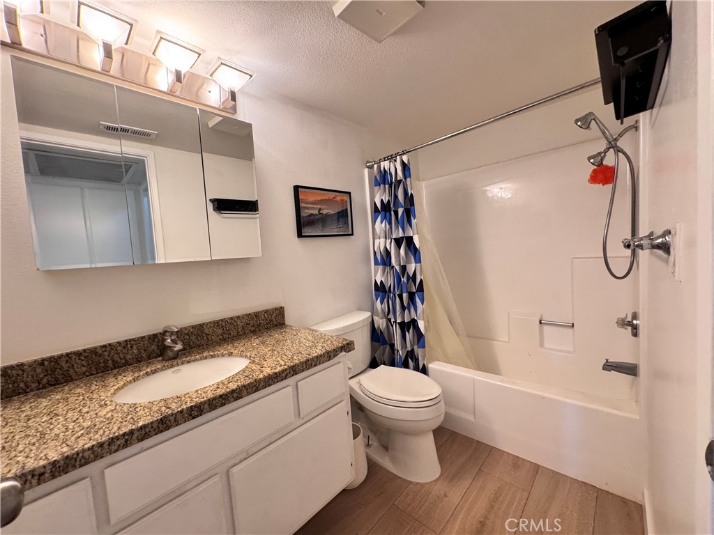 25611 Quail Run, Unit 61 Dana Point, CA 92629 - Photo 23 of 29 a bathroom with a granite countertop sink toilet and shower