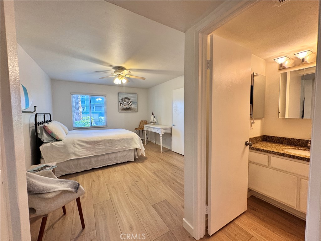 25611 Quail Run, Unit 61 Dana Point, CA 92629 - Photo 24 of 29 a bedroom with a bed and a chandelier