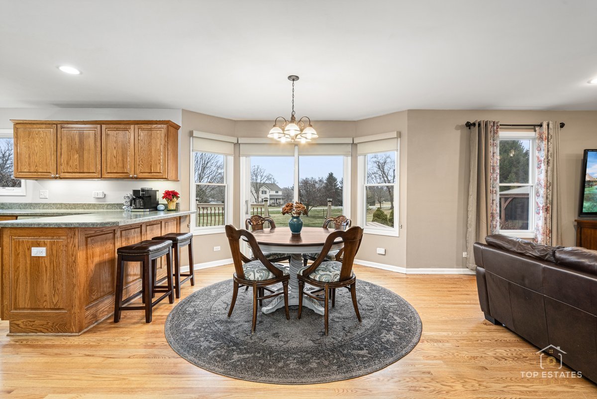 2303 Fox Bluff Lane Spring Grove, IL 60081 - Photo 11 of 39 a view of a dining room with furniture window and outside view