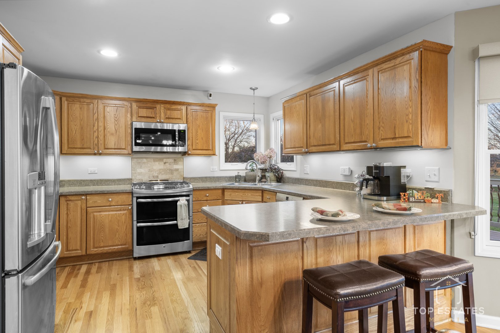 2303 Fox Bluff Lane Spring Grove, IL 60081 - Photo 13 of 39 a kitchen with stainless steel appliances granite countertop a sink stove and refrigerator