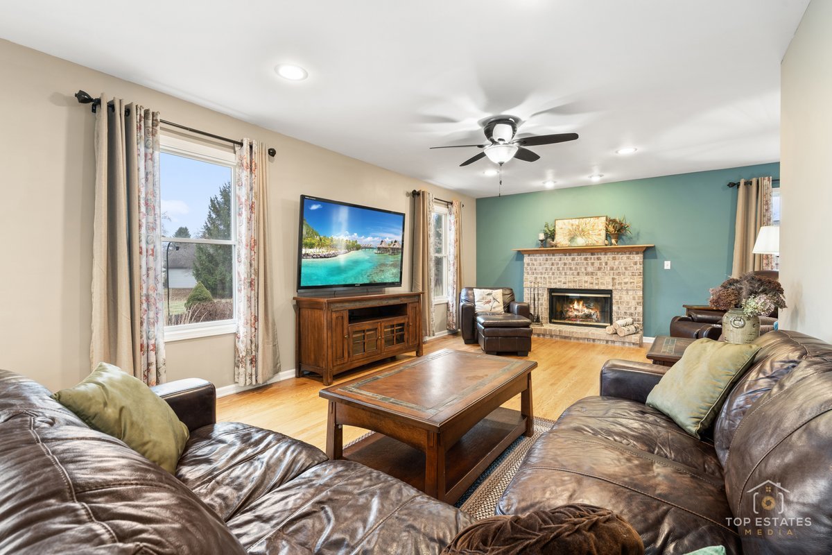 2303 Fox Bluff Lane Spring Grove, IL 60081 - Photo 17 of 39 a living room with furniture a flat screen tv and a fireplace