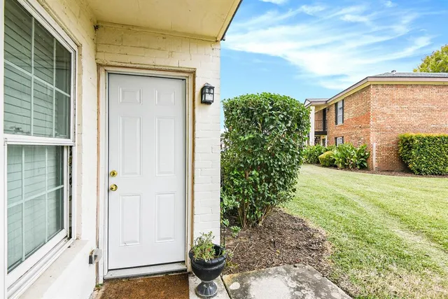 a couple of potted plants in front of door
