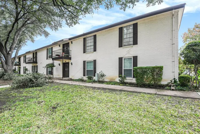 a view of staircase with white walls and a window