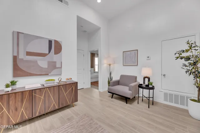 a living room with furniture and wooden floor