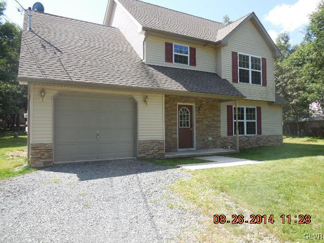 402 Mountain Road Albrightsville, PA 18210 - Photo 1 of 11 a front view of a house with a yard and garage