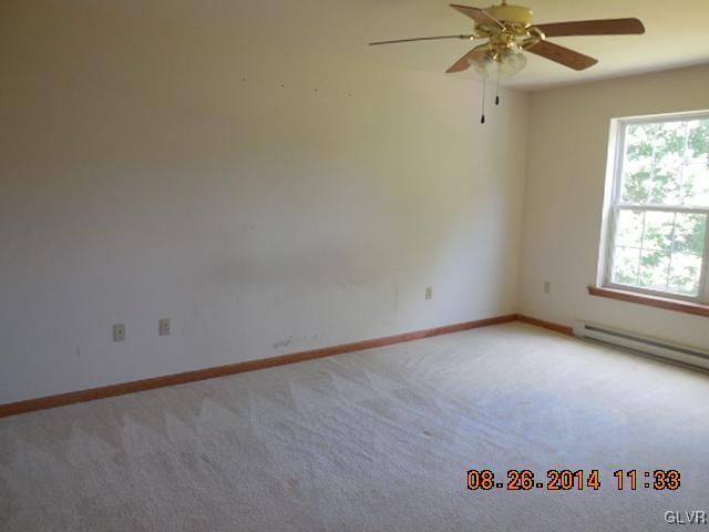 402 Mountain Road Albrightsville, PA 18210 - Photo 8 of 11 an empty room with a window and a ceiling fan