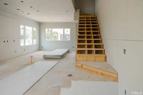 a spacious bedroom with a bed and a window