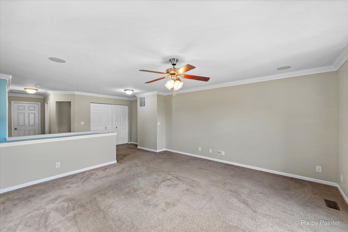6-n307 Whitmore Circle, Unit A St. Charles, IL 60174 - Photo 13 of 18 an empty room with fan and windows