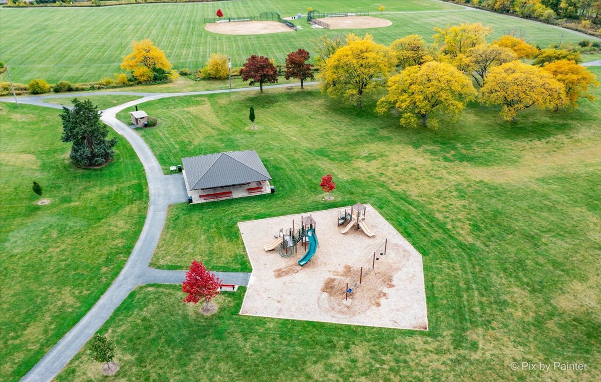 6-n307 Whitmore Circle, Unit A St. Charles, IL 60174 - Photo 18 of 18 a view of a table and chairs in the garden