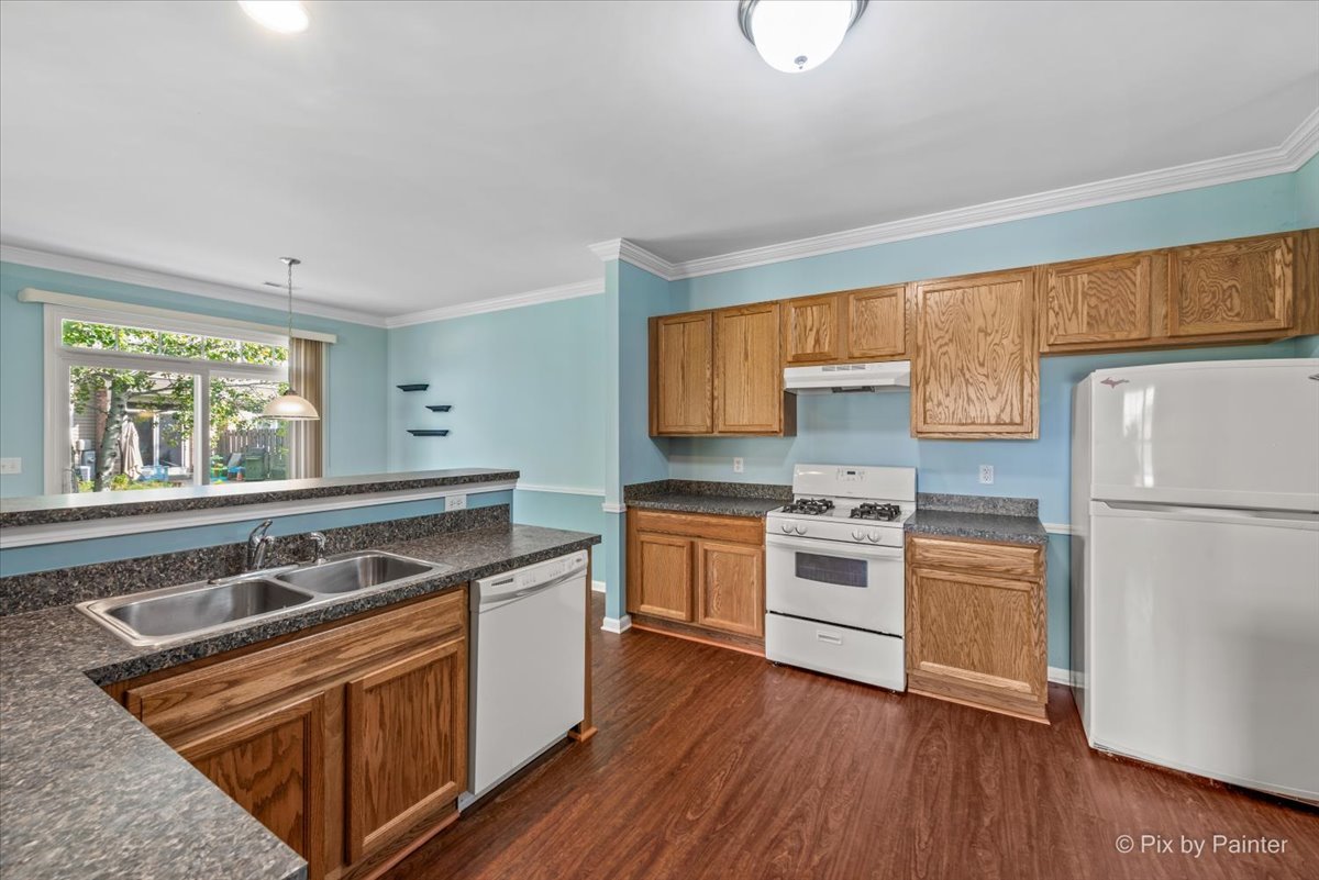 6-n307 Whitmore Circle, Unit A St. Charles, IL 60174 - Photo 2 of 18 a kitchen with a stove a sink wooden floor and a window