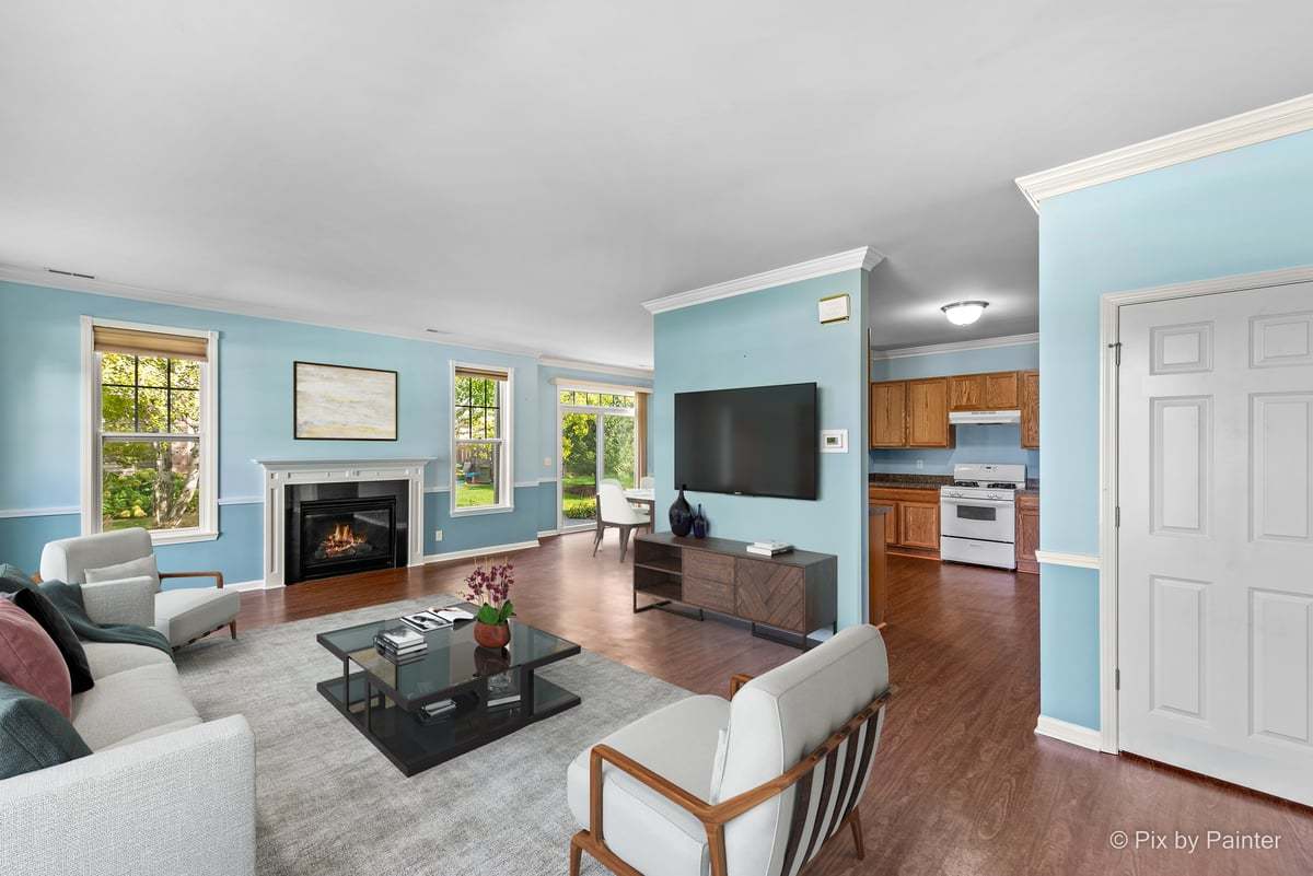 6-n307 Whitmore Circle, Unit A St. Charles, IL 60174 - Photo 4 of 18 a living room with furniture a fireplace and a flat screen tv