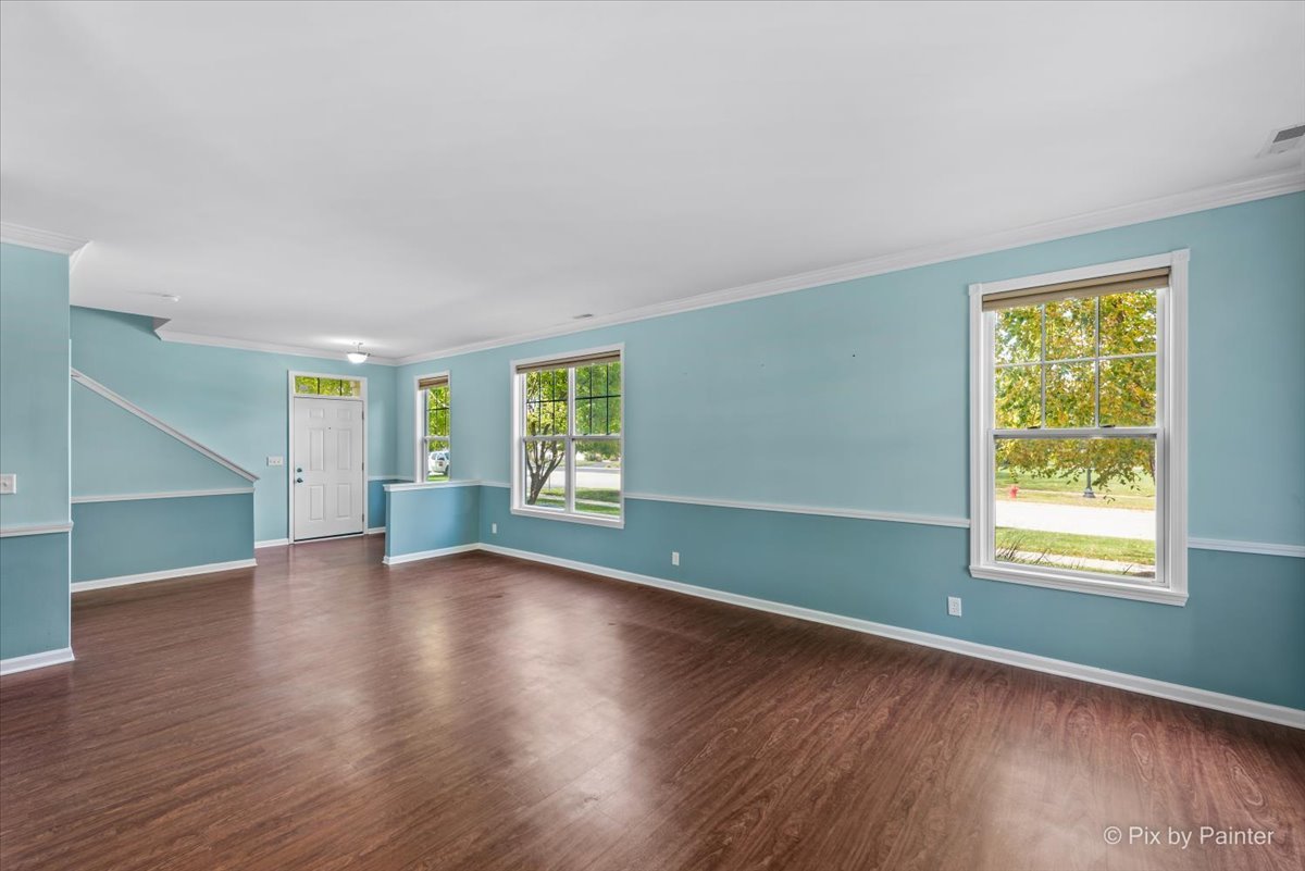 6-n307 Whitmore Circle, Unit A St. Charles, IL 60174 - Photo 5 of 18 an empty room with wooden floor and windows