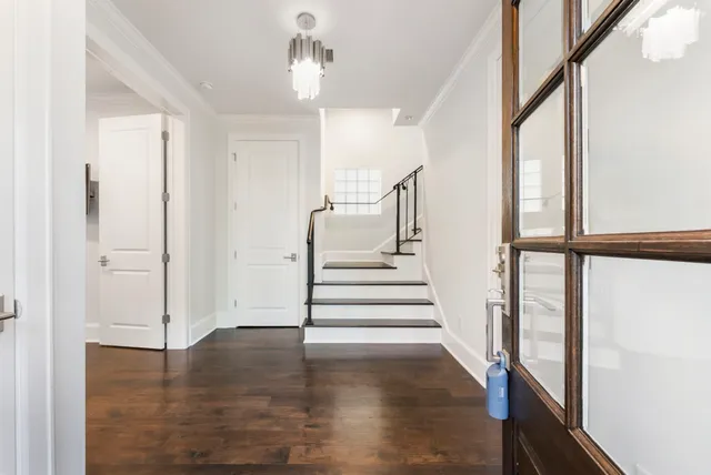 a view of entryway with wooden floor and stair