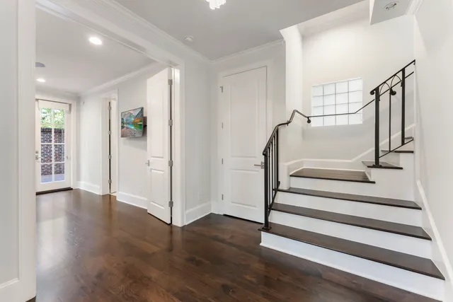 a view of entryway with wooden floor and stairs