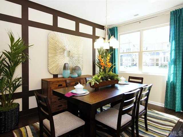 702 Wickham Ridge Road Apex, NC 27539 - Photo 10 of 10 a view of a dining room with furniture window and wooden floor
