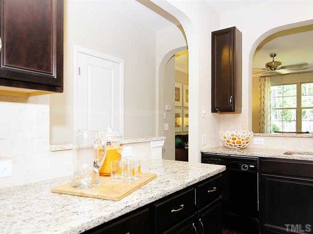 702 Wickham Ridge Road Apex, NC 27539 - Photo 1 of 10 a bathroom with a granite countertop sink and a mirror