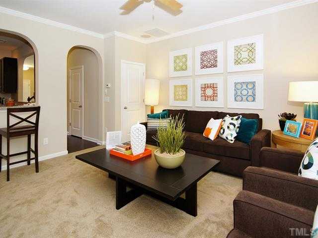 702 Wickham Ridge Road Apex, NC 27539 - Photo 4 of 10 a living room with furniture and wall paintings