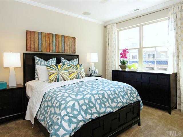 702 Wickham Ridge Road Apex, NC 27539 - Photo 5 of 10 a bedroom with a bed and window