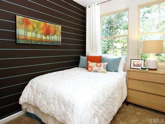 702 Wickham Ridge Road Apex, NC 27539 - Photo 6 of 10 a bed sitting in a bedroom next to a window