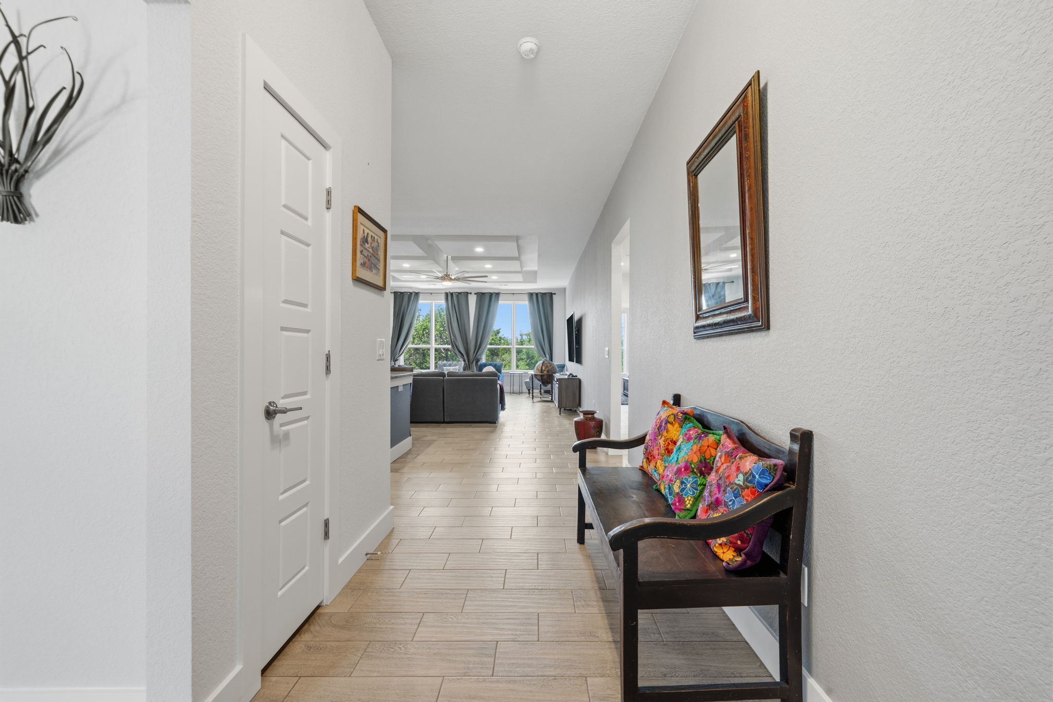 18605 Masters Cove Point Venture, TX 78645 - Photo 2 of 40 Hallway featuring wood-finish flooring, white paneled interior doors, and a vaulted ceiling in the background