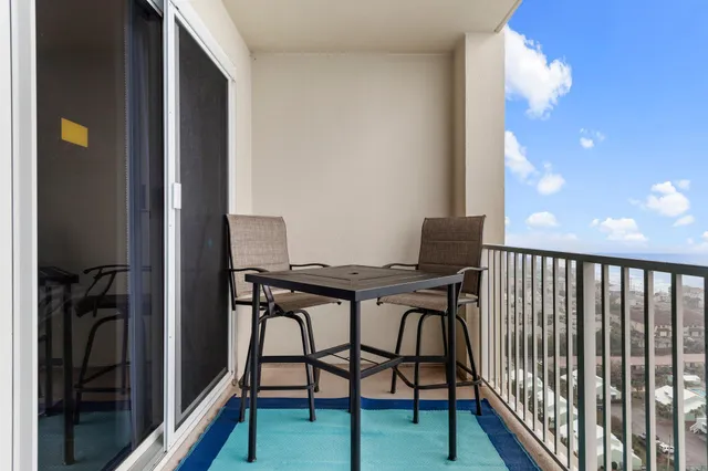 a roof deck with table and chairs