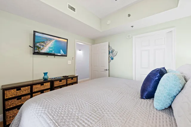 a bedroom with a bed and a painting on the wall