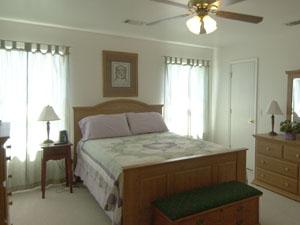 5015 Capulin Lane Amarillo, TX 79110 - Photo 4 of 9 a bedroom with a bed and a chandelier