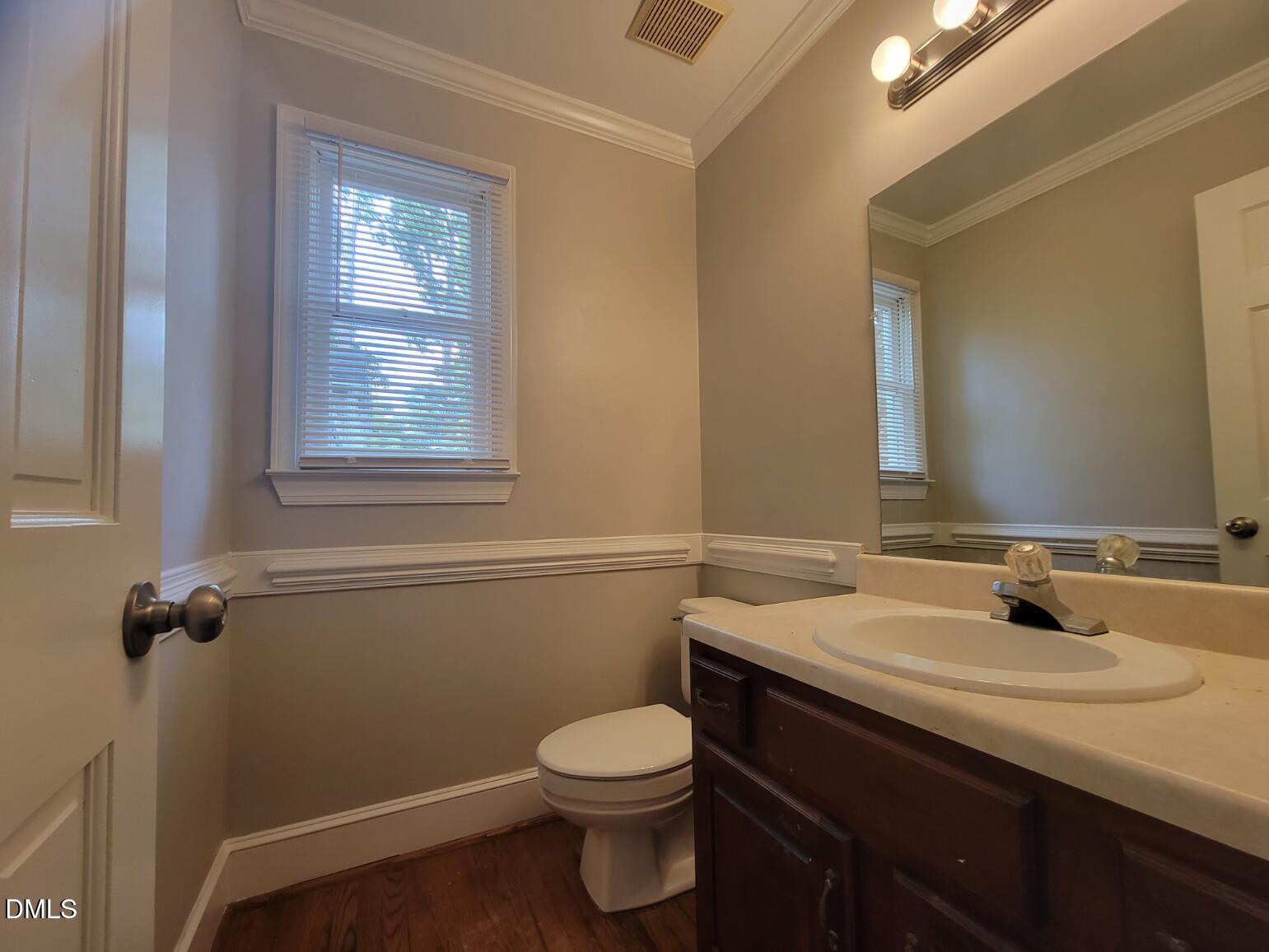 105 Leeward Court Cary, NC 27511 - Photo 12 of 27 a bathroom with a sink a toilet and a mirror