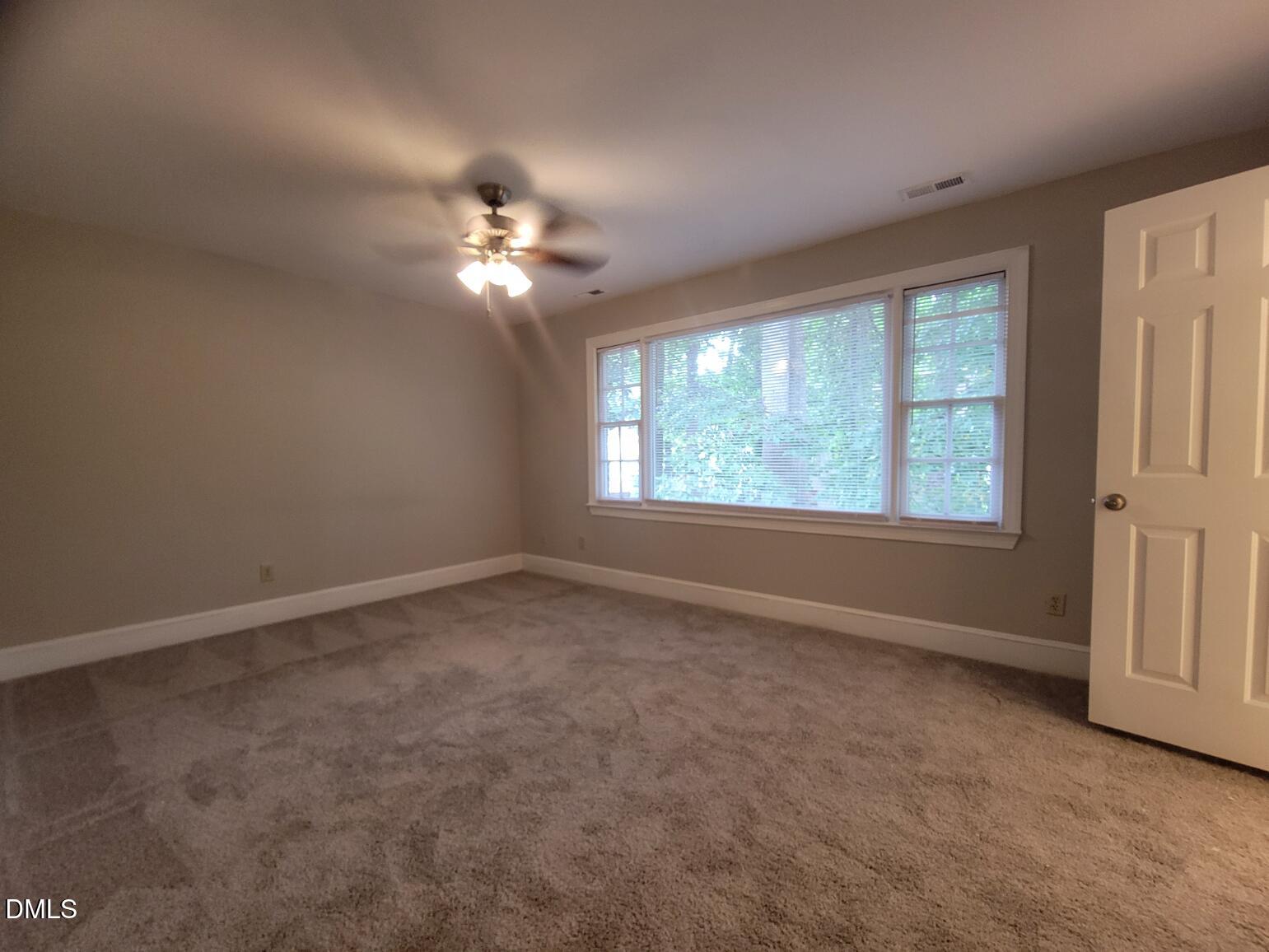 105 Leeward Court Cary, NC 27511 - Photo 14 of 27 an empty room with windows and fan