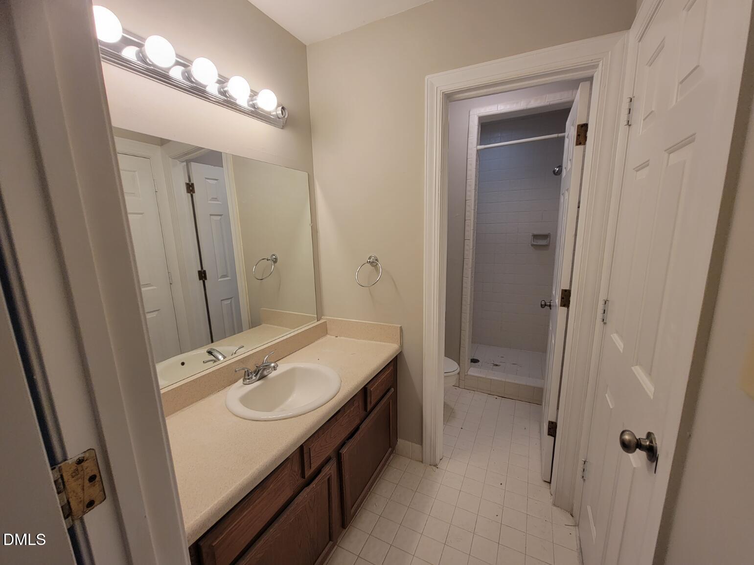 105 Leeward Court Cary, NC 27511 - Photo 16 of 27 a bathroom with a sink a toilet and shower