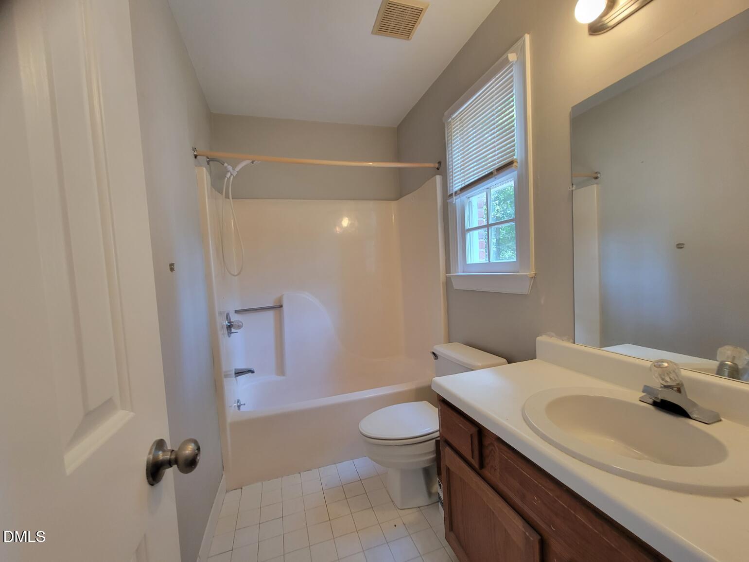 105 Leeward Court Cary, NC 27511 - Photo 19 of 27 a bathroom with a sink a toilet and shower