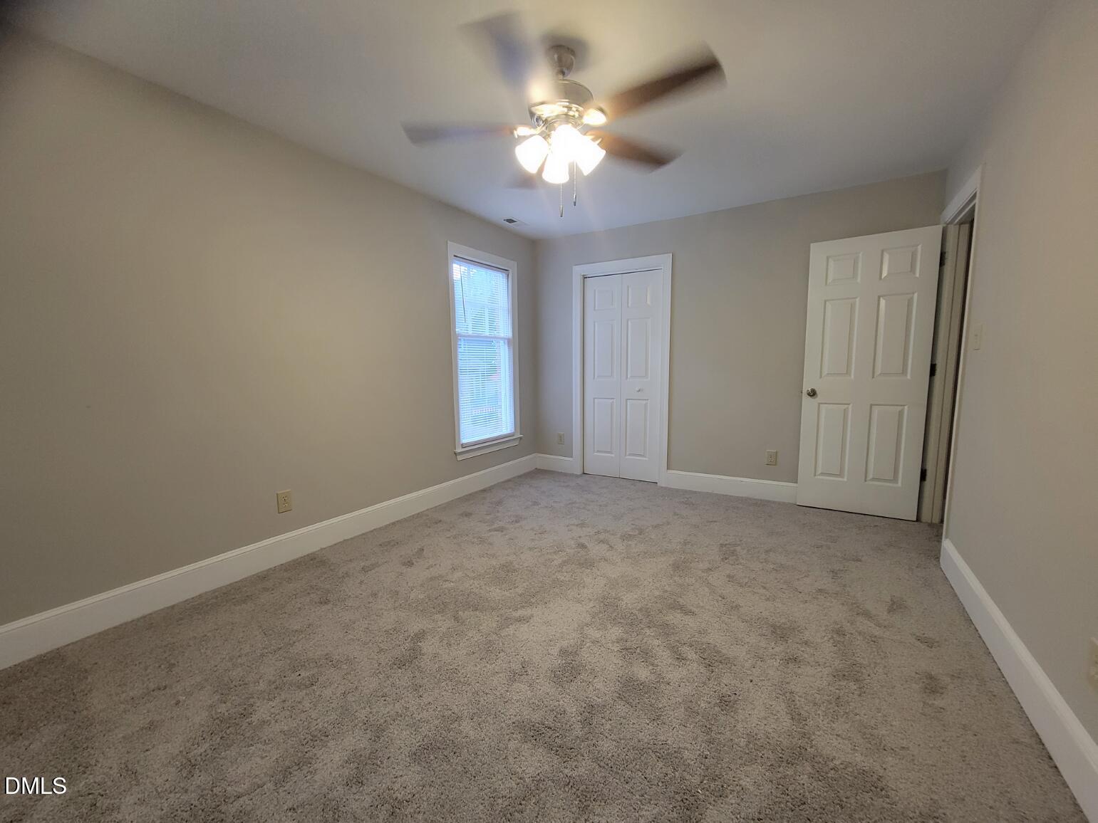 105 Leeward Court Cary, NC 27511 - Photo 21 of 27 a view of a room with a ceiling fan and a window