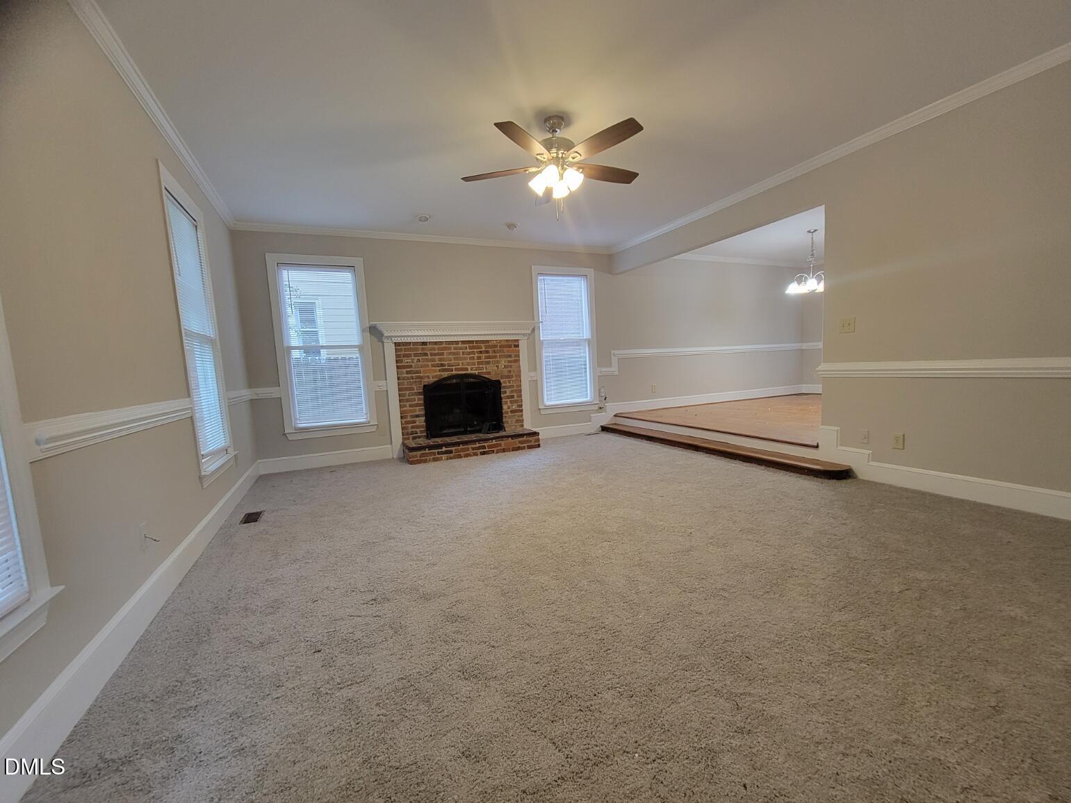 105 Leeward Court Cary, NC 27511 - Photo 3 of 27 a view of an empty room with a fireplace
