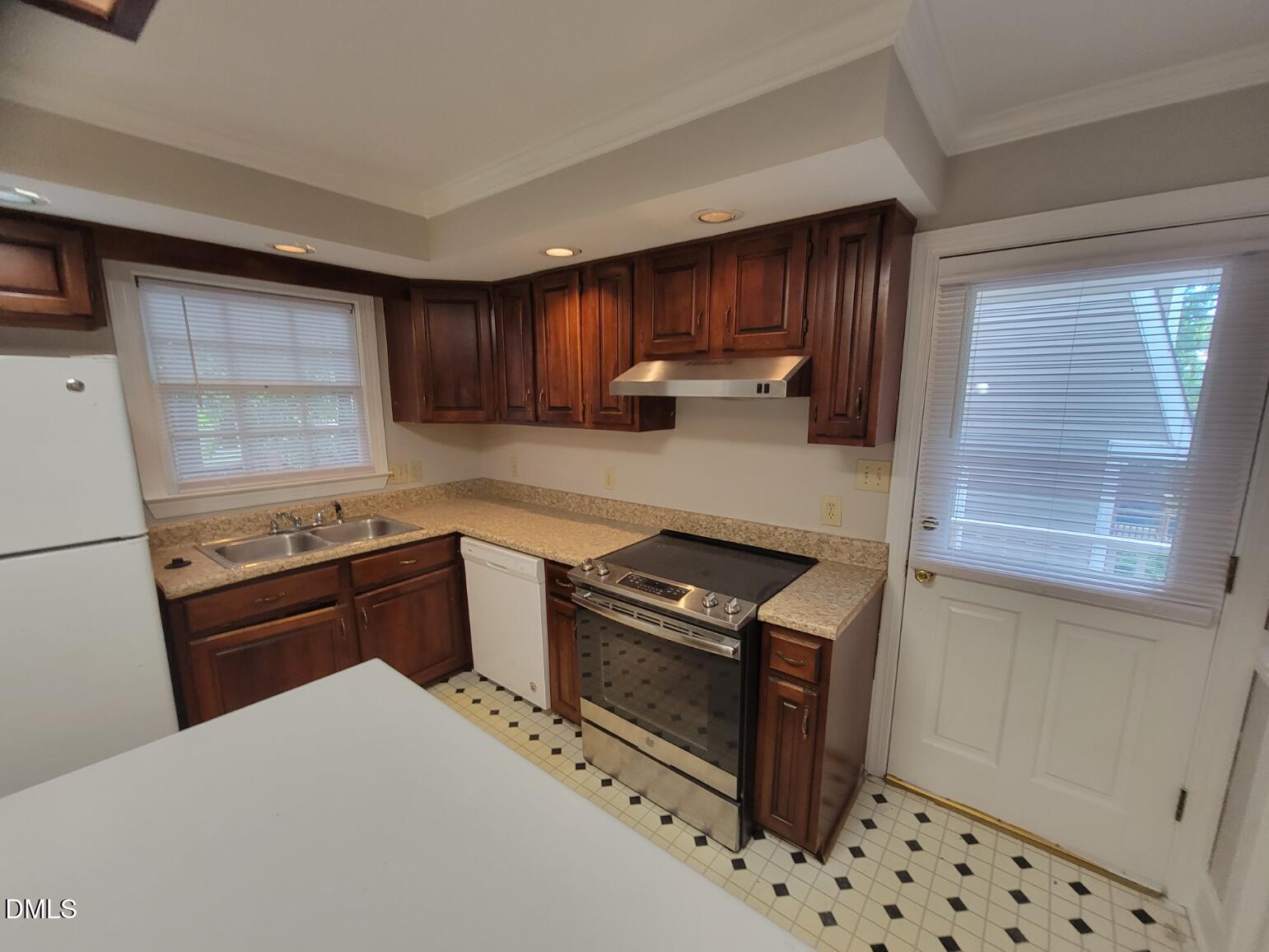 105 Leeward Court Cary, NC 27511 - Photo 7 of 27 a kitchen with granite countertop a stove and a refrigerator
