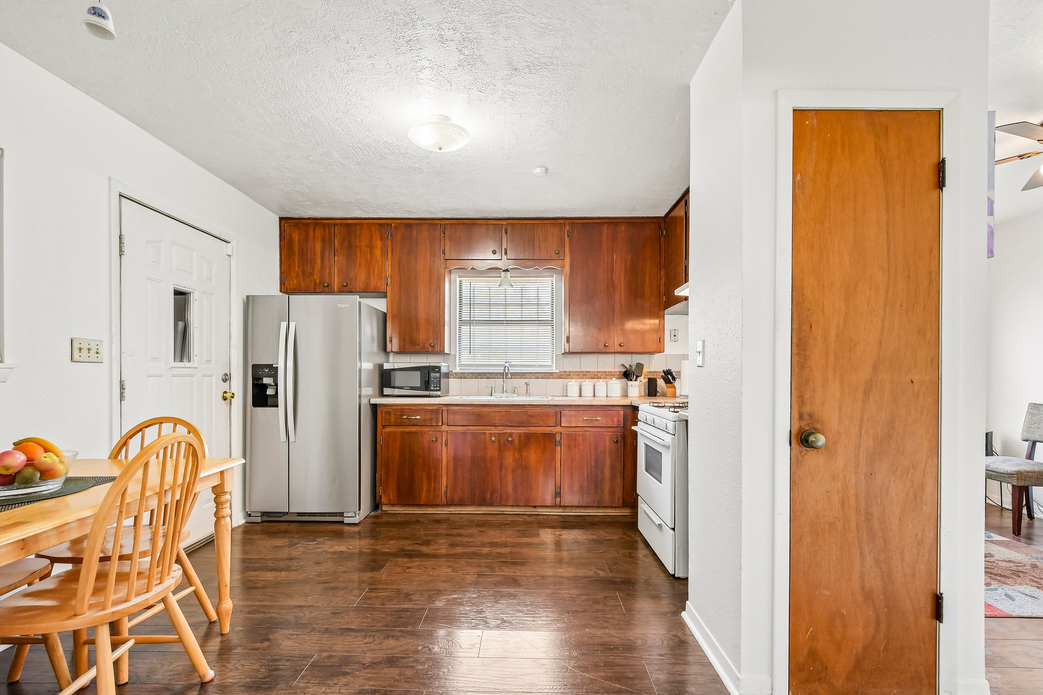 101 Brown Street Elgin, TX 78621 - Photo 12 of 32 a kitchen with stainless steel appliances granite countertop a refrigerator and a stove top oven