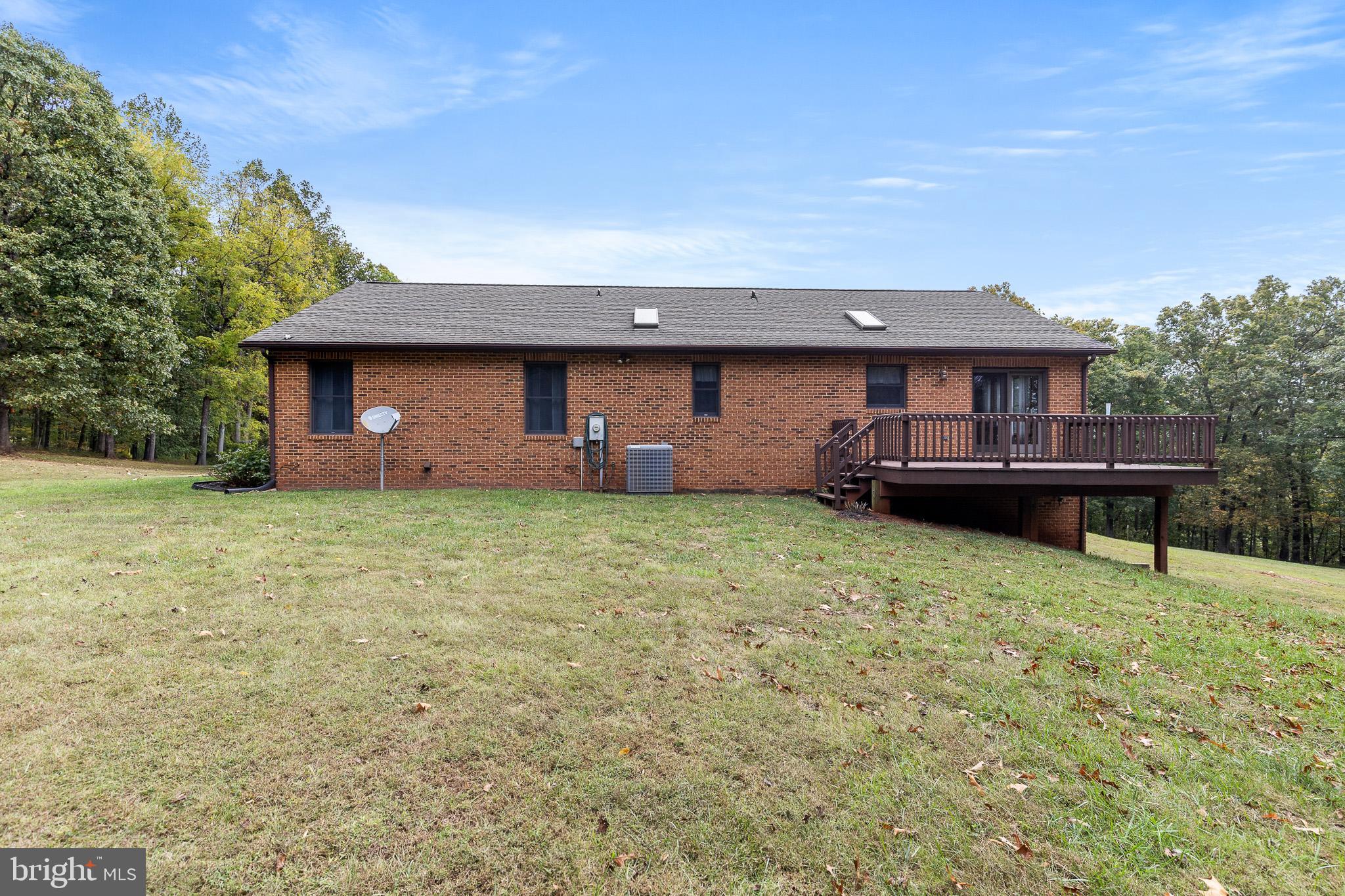 21246 Clarks Mountain Road Rapidan, VA 22733 - Photo 5 of 38 a front view of a house with a garden and deck