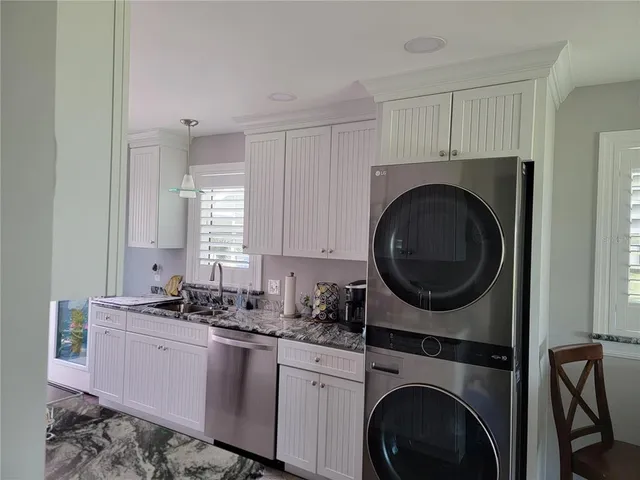 a kitchen with sink a washer and dryer