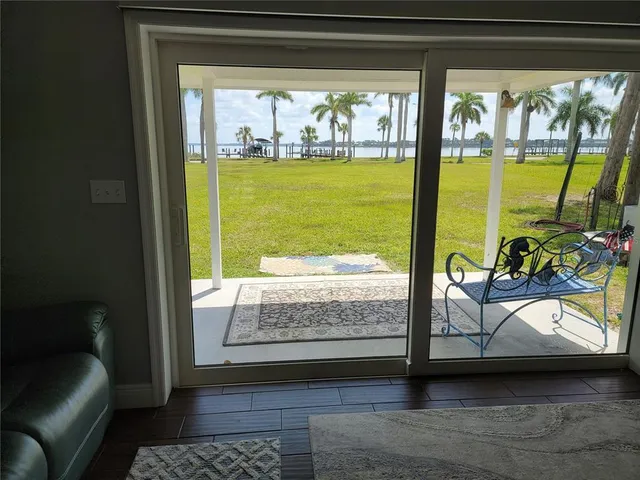 a view of living room with furniture and floor to ceiling window