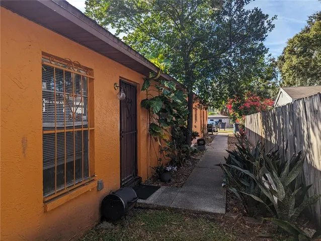 a view of a house with backyard and sitting area