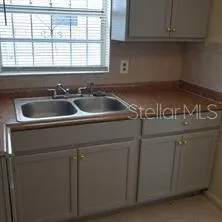 a kitchen with sink and cabinets