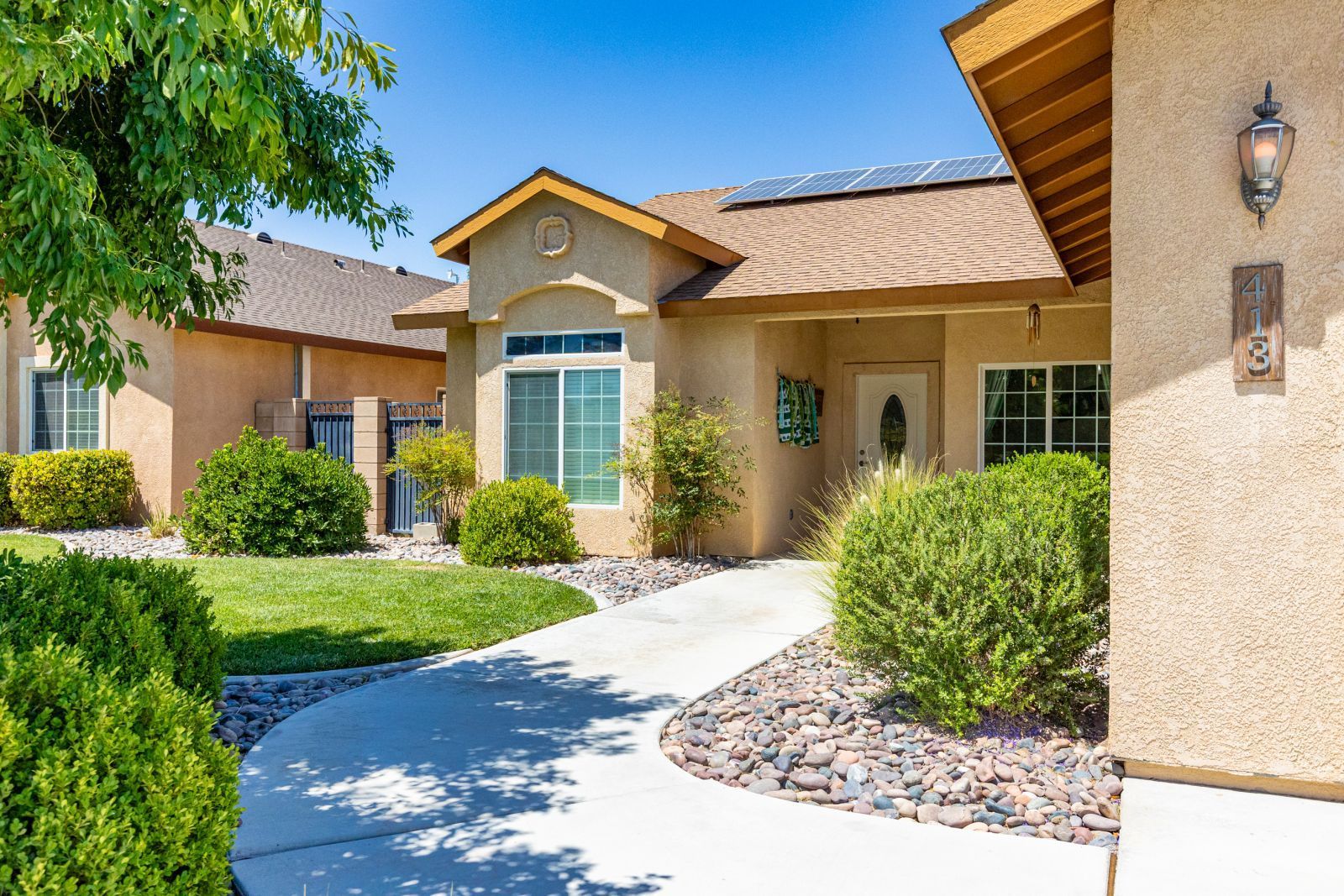 413 Acacia Street Ridgecrest, CA 93555 - Photo 2 of 34 a front view of a house with a yard
