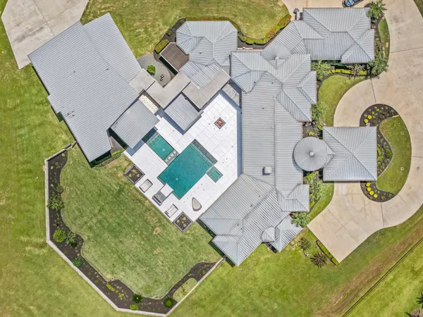 an aerial view of a house with a swimming pool
