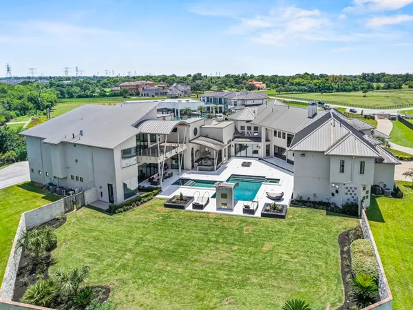 an aerial view of a house with a garden and lake view
