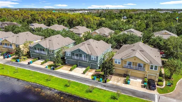 an aerial view of multiple houses with a yard