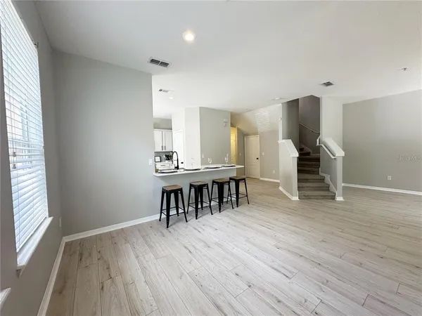 an empty room with wooden floor and furniture